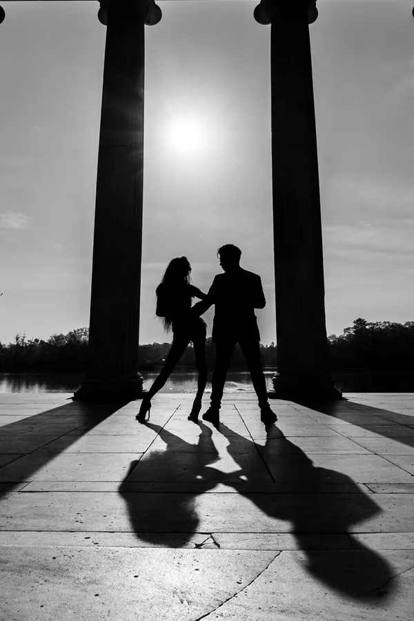 Couple silhouetted between classical columns