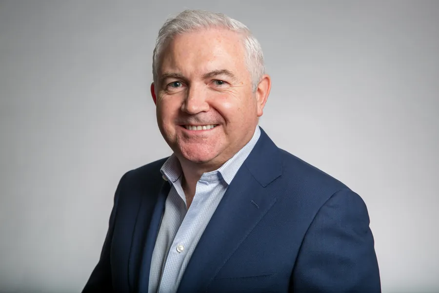 Executive headshot in a navy suit