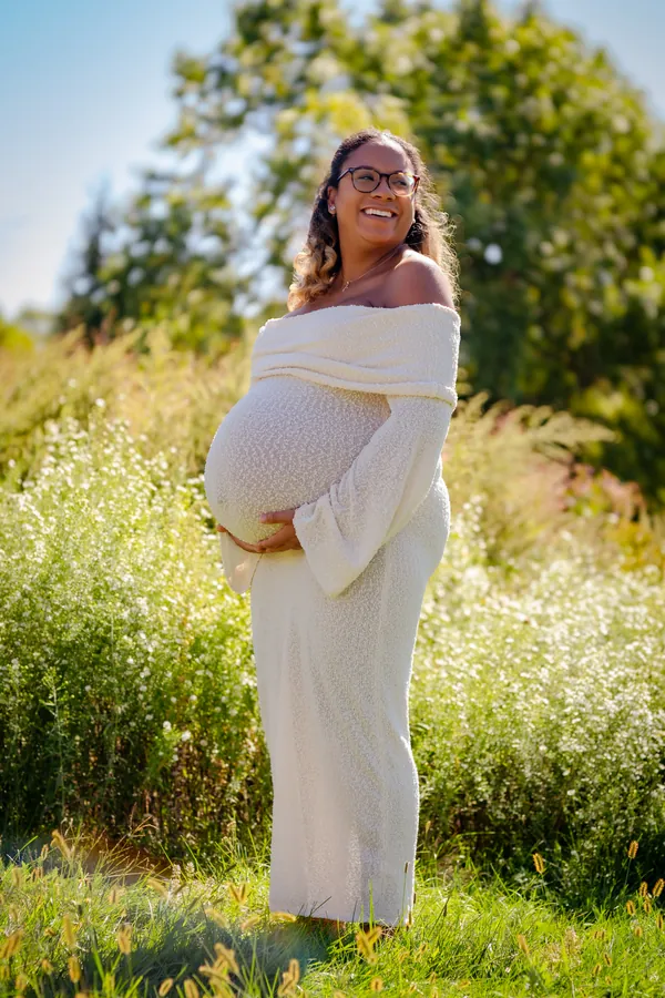 Expectant mother in a sunlit field