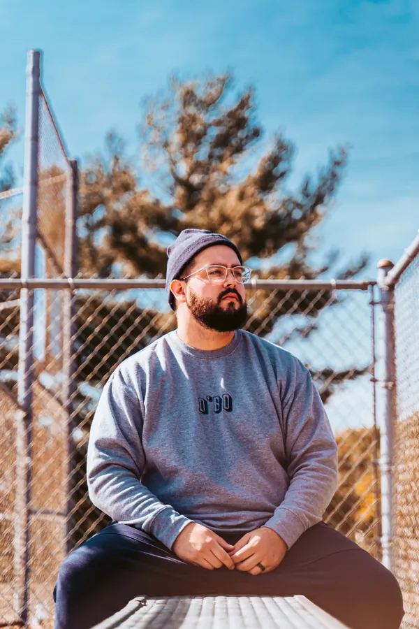 Q’Bo launch: man seated against a blue sky