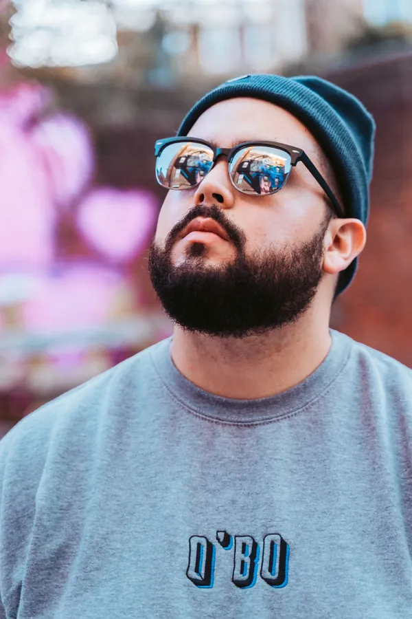 Q’Bo launch: portrait in sunglasses against a pink wall