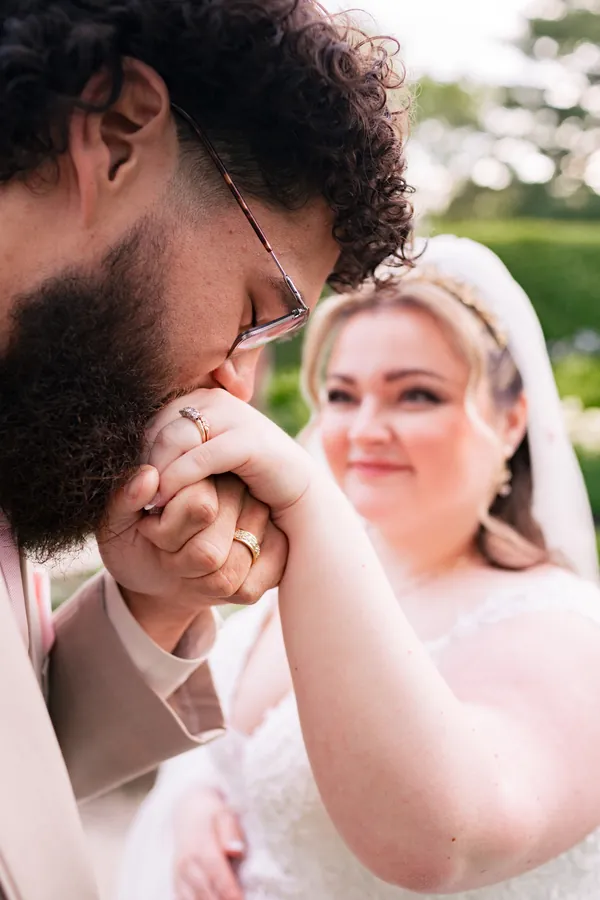 Groom kissing the bride’s hand